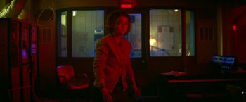 Movie still from “A Quiet Place Part II” (2020), directed by John Krasinski – A person standing in a room with a window in the background; Medium shot, Low angle