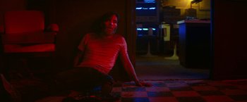 Movie still from “A Quiet Place Part II” (2020), directed by John Krasinski – A man sitting on the ground in a room; Medium shot, Low angle