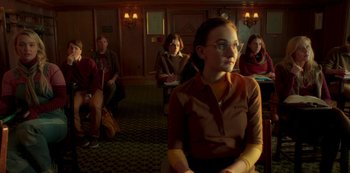 Movie still from “A Rainy Day in New York” (2019), directed by Woody Allen – A group of people sitting in a room; Medium shot, Over the shoulder angle