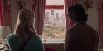 Movie still from “A Rainy Day in New York” (2019), directed by Woody Allen – Two women are looking out a window at a city skyline; Medium shot, Over the shoulder angle