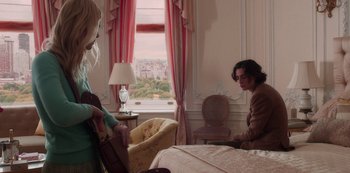Movie still from “A Rainy Day in New York” (2019), directed by Woody Allen – Two people in a room with a large window; Wide shot, Over the shoulder angle