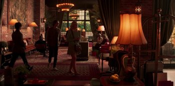 Movie still from “A Rainy Day in New York” (2019), directed by Woody Allen – Two women are standing in a hotel lobby; Wide shot, Over the shoulder angle