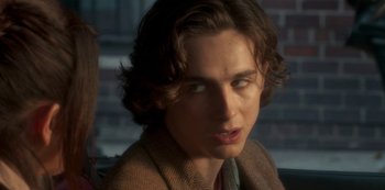 Movie still from “A Rainy Day in New York” (2019), directed by Woody Allen – A person wearing a jacket; Close Up shot, Over the shoulder angle
