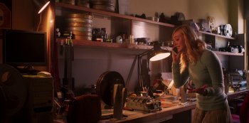 Movie still from “A Rainy Day in New York” (2019), directed by Woody Allen – A woman talking on a phone in a room; Medium shot, Low angle