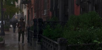 Movie still from “A Rainy Day in New York” (2019), directed by Woody Allen – A row of buildings on a city street; Extreme Wide shot, High angle