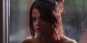 Movie still from “A Rainy Day in New York” (2019), directed by Woody Allen – A person wearing a yellow sweater; Close Up shot, Over the shoulder angle