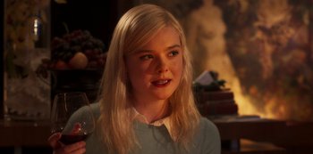 Movie still from “A Rainy Day in New York” (2019), directed by Woody Allen – A woman holding a glass of wine in her hand; Close Up shot, Over the shoulder angle