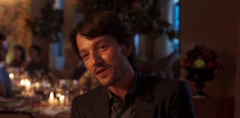 Movie still from “A Rainy Day in New York” (2019), directed by Woody Allen – A person wearing a suit and tie; Close Up shot, Over the shoulder angle