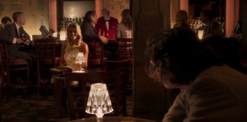Movie still from “A Rainy Day in New York” (2019), directed by Woody Allen – A group of people sitting at a table in a restaurant; Medium shot, Over the shoulder angle