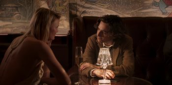 Movie still from “A Rainy Day in New York” (2019), directed by Woody Allen – A man and a woman sitting at a table with a glass of wine; Medium shot, Over the shoulder angle