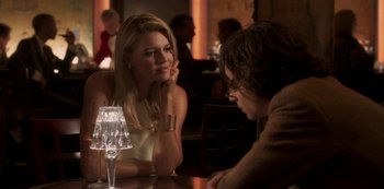 Movie still from “A Rainy Day in New York” (2019), directed by Woody Allen – A woman sitting at a table talking to a man; Medium shot, Over the shoulder angle