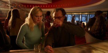 Movie still from “A Rainy Day in New York” (2019), directed by Woody Allen – A man and a woman sitting at a bar drinking wine; Medium shot, Low angle