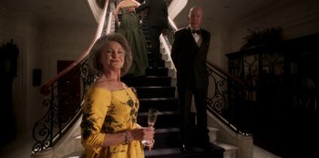Movie still from “A Rainy Day in New York” (2019), directed by Woody Allen – A man and a woman standing in front of a staircase; Medium shot, Low angle