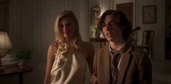 Movie still from “A Rainy Day in New York” (2019), directed by Woody Allen – A man and a woman standing next to each other in a room; Medium shot, Over the shoulder angle