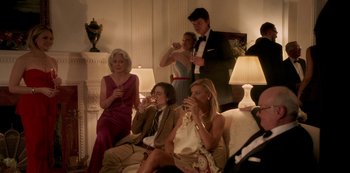 Movie still from “A Rainy Day in New York” (2019), directed by Woody Allen – A group of people sitting on top of a white couch; Wide shot, Low angle
