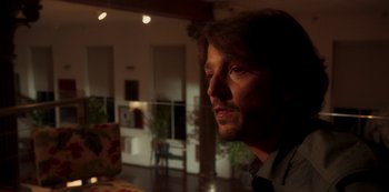 Movie still from “A Rainy Day in New York” (2019), directed by Woody Allen – A person wearing a tie in a room; Close Up shot, Low angle