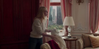 Movie still from “A Rainy Day in New York” (2019), directed by Woody Allen – A woman in a white sweater is holding a white cloth; Medium shot, Over the shoulder angle