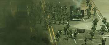 Movie still from “A Taxi Driver” (2017), directed by Hun Jang – A large group of soldiers marching down a street; Extreme Wide shot, High angle