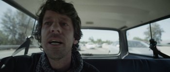 Movie still from “A Thousand Junkies” (2017), directed by Tommy Swerdlow – A person in a car; Close Up shot, Low angle