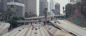Movie still from “A Thousand Junkies” (2017), directed by Tommy Swerdlow – A busy highway with a lot of cars on it; Extreme Wide shot, High angle