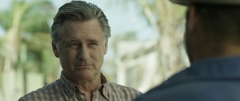 Movie still from “A Thousand Junkies” (2017), directed by Tommy Swerdlow – A person wearing a plaid shirt; Close Up shot, Over the shoulder angle