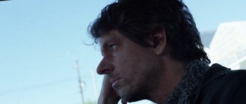 Movie still from “A Thousand Junkies” (2017), directed by Tommy Swerdlow – A person with his hand on his face; Close Up shot, Low angle