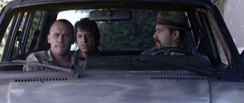 Movie still from “A Thousand Junkies” (2017), directed by Tommy Swerdlow – A group of men sitting in the back seat of a car; Close Up shot, Over the shoulder angle