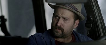 Movie still from “A Thousand Junkies” (2017), directed by Tommy Swerdlow – A person wearing a hat; Close Up shot, Low angle
