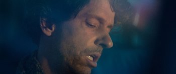 Movie still from “A Thousand Junkies” (2017), directed by Tommy Swerdlow – A man's face with his mouth open; Extreme Close Up shot, Low angle