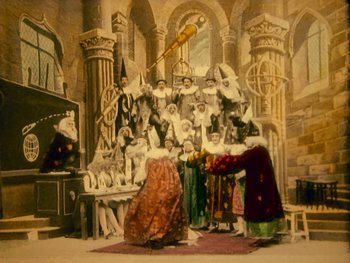 Movie still from “A Trip to the Moon” (1902), directed by Georges Méliès – A painting of a group of people dressed in medieval clothing; Wide shot, Low angle