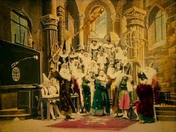 Movie still from “A Trip to the Moon” (1902), directed by Georges Méliès – A group of people dressed in medieval costumes; Wide shot, Low angle