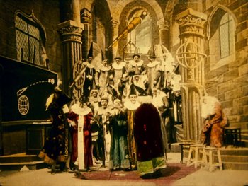 Movie still from “A Trip to the Moon” (1902), directed by Georges Méliès – A group of people dressed in medieval costumes; Extreme Wide shot, Low angle