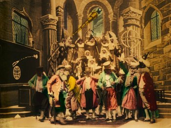 Movie still from “A Trip to the Moon” (1902), directed by Georges Méliès – A group of people dressed in costumes posing for a picture; Wide shot, Low angle
