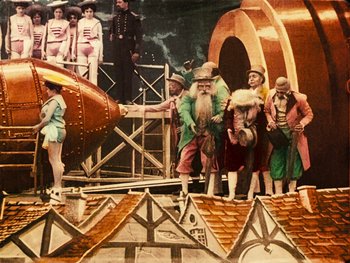 Movie still from “A Trip to the Moon” (1902), directed by Georges Méliès – A group of men standing next to each other on top of a building; Extreme Wide shot, Low angle
