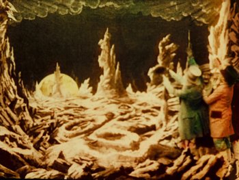 Movie still from “A Trip to the Moon” (1902), directed by Georges Méliès – A painting of a man standing in the middle of a cave; Wide shot, High angle