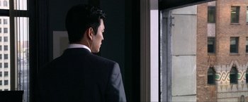 Movie still from “A Very Harold & Kumar Christmas” (2011), directed by Todd Strauss-Schulson – A man in a suit looking out of a window; Close Up shot, Over the shoulder angle