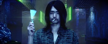 Movie still from “A Very Harold & Kumar Christmas” (2011), directed by Todd Strauss-Schulson – A man smoking a cigarette while holding a cell phone in his hand; Medium shot, Low angle