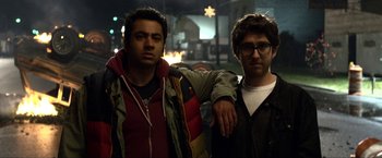 Movie still from “A Very Harold & Kumar Christmas” (2011), directed by Todd Strauss-Schulson – A couple of men standing next to each other; Medium shot, Over the shoulder angle