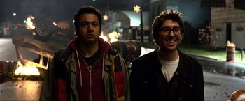 Movie still from “A Very Harold & Kumar Christmas” (2011), directed by Todd Strauss-Schulson – Two men standing next to each other on a city street; Close Up shot, Over the shoulder angle