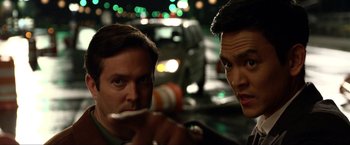 Movie still from “A Very Harold & Kumar Christmas” (2011), directed by Todd Strauss-Schulson – Two men in the street one is brushing his teeth; Close Up shot, Over the shoulder angle