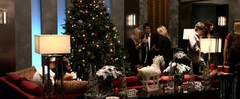 A group of people standing around a christmas tree