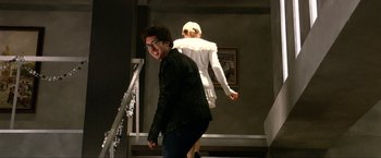 A man and a woman are walking down a staircase