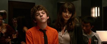 Movie still from “A Very Harold & Kumar Christmas” (2011), directed by Todd Strauss-Schulson – A boy and a girl standing next to each other in a room; Close Up shot, Over the shoulder angle