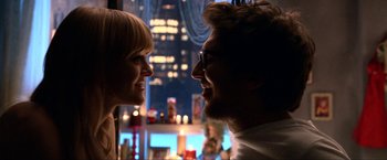 Movie still from “A Very Harold & Kumar Christmas” (2011), directed by Todd Strauss-Schulson – A man and a woman smiling at each other in front of a window; Close Up shot, Overhead angle