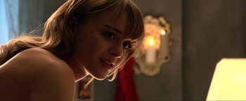 Movie still from “A Very Harold & Kumar Christmas” (2011), directed by Todd Strauss-Schulson – A woman's face with a candle in the background; Close Up shot, Over the shoulder angle