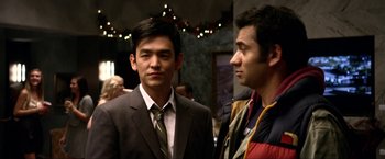Movie still from “A Very Harold & Kumar Christmas” (2011), directed by Todd Strauss-Schulson – Two men in suits standing next to each other; Close Up shot, Over the shoulder angle