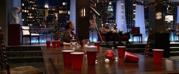 Movie still from “A Very Harold & Kumar Christmas” (2011), directed by Todd Strauss-Schulson – A group of people sitting around a table with red cups; Wide shot, Over the shoulder angle