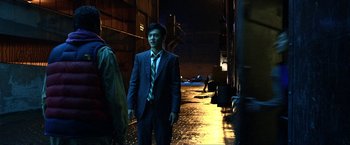 Movie still from “A Very Harold & Kumar Christmas” (2011), directed by Todd Strauss-Schulson – A man in a suit standing in the dark; Medium shot, Over the shoulder angle