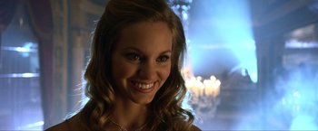 Movie still from “A Very Harold & Kumar Christmas” (2011), directed by Todd Strauss-Schulson – A beautiful young lady smiling for the camera; Close Up shot, Over the shoulder angle