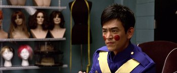 Movie still from “A Very Harold & Kumar Christmas” (2011), directed by Todd Strauss-Schulson – A man with a clown face paint in front of mannequins; Close Up shot, Over the shoulder angle